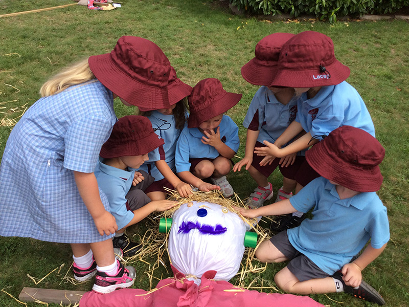 Children making a scarecrow